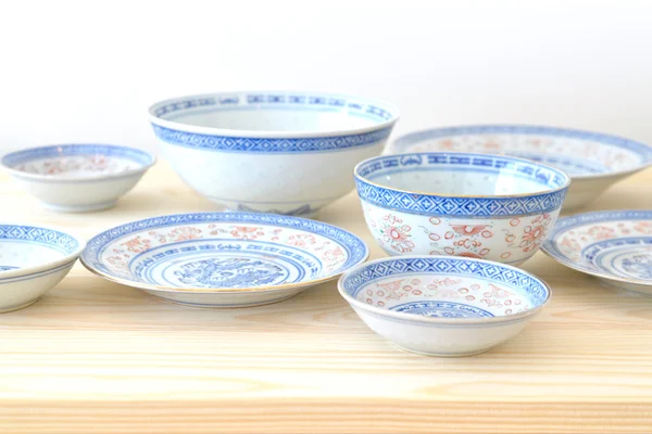 Chinese vintage style blue and white dishes, plate and bowl on the cupboard at home.