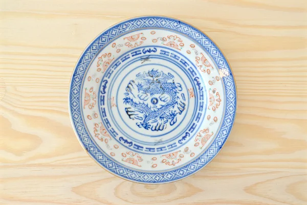 Chinese vintage style blue and white dishes, plate and bowl on the cupboard at home.