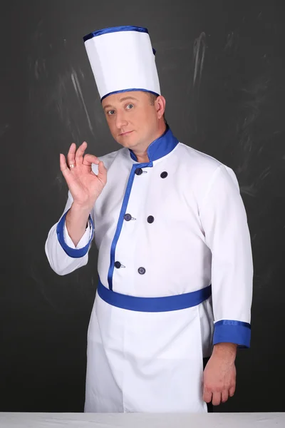 Portrait of chef and hand doing gesture is all right
