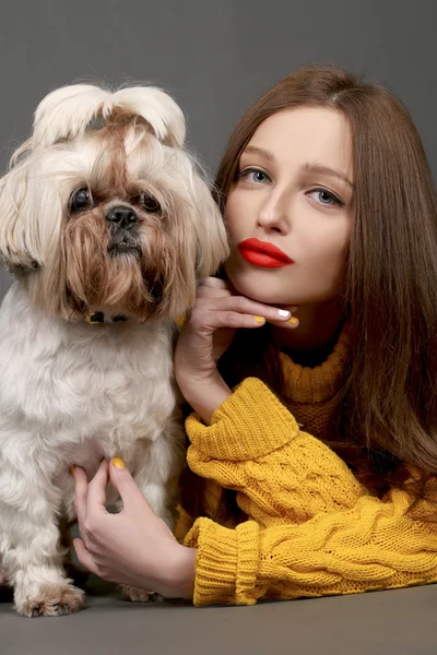 Beautiful girl with red lips and adorable Shih-tzu dog