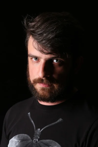 Bearded man with serious look. Close.up. Black
