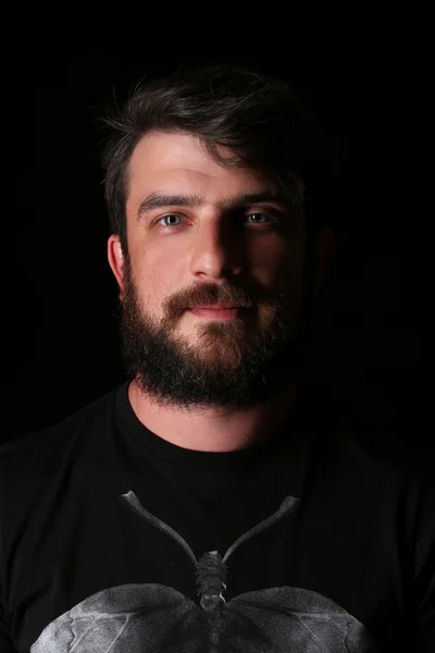 Portrait of bearded guy with kind eyes. Close.up. Black