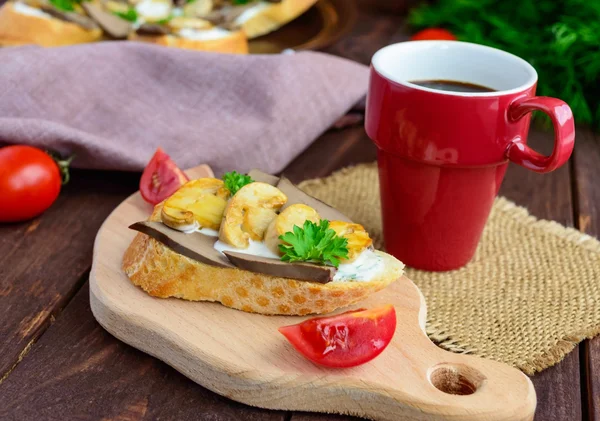 Sandwiches with mushrooms, turkey liver and tartar sauce on crispy baguette and a cup of coffee