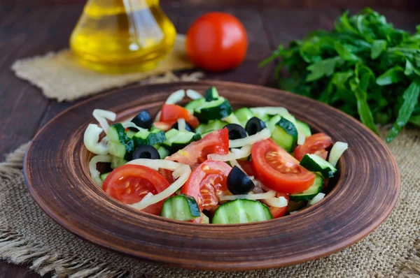 Dietary salad with vegetables, olives and oil. Mediterranean Kitchen