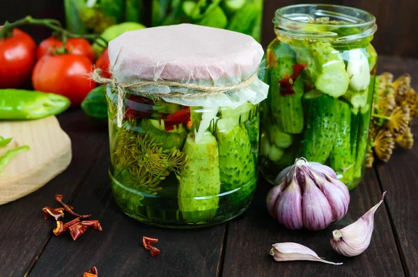 Pickled cucumbers in glass jars. Spices and vegetables for preparation of pickles