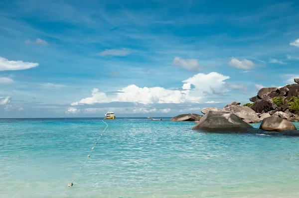 A scenic view on tropical beach with rocks, ocean, clouds and sky. Similan islands, Thailand, Phuket