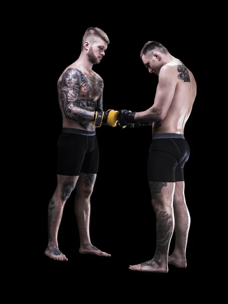 Mixed martial artists before a fight on black background