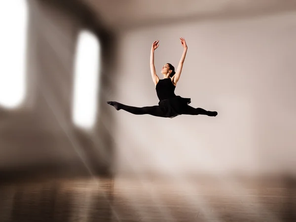 Woman dancer jump posing on background