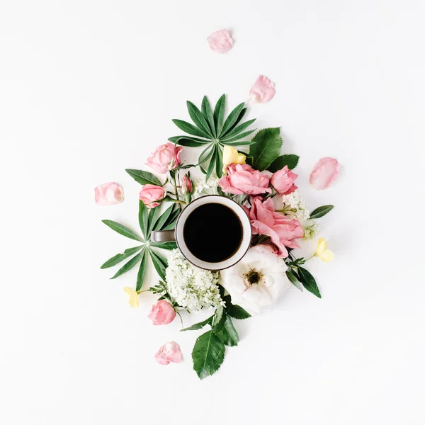 Black coffee mug among flowers