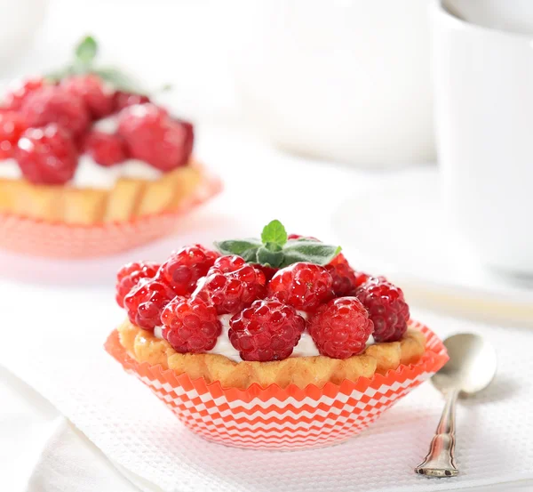 Tasty cakes with raspberries