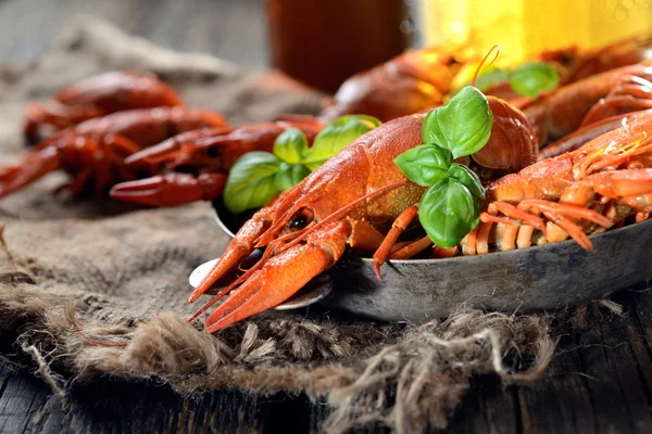 Boiled crawfishes and basil leaves