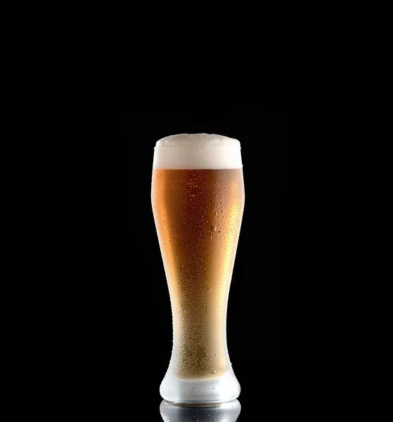 Glass of beer on a black