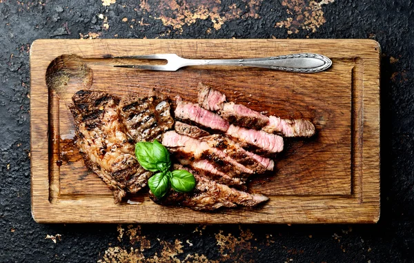 Grilled steaks on a cutting board