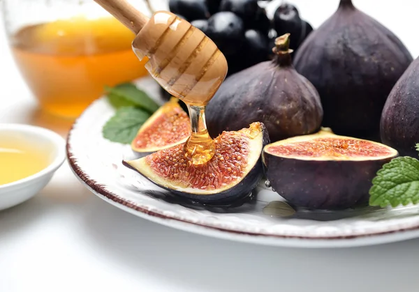 Grapes, sliced figs and flowing honey