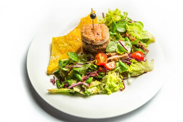 Chicken and beef Patty with toast and a salad of greens and cherry tomatoes