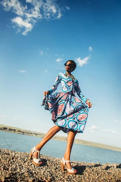 Black young model in a blue African dress