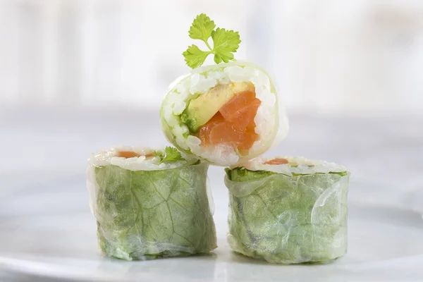 Makizushi. Delicious sushi rolls on white plate with chopsticks