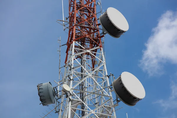 Close up antenna repeater tower on blue sky.