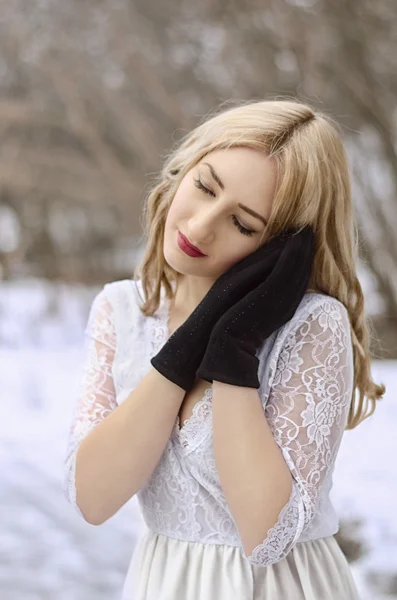 Winter woman in a dress and black gloves