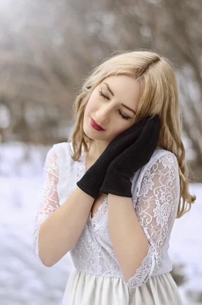 Winter woman in a dress and black gloves