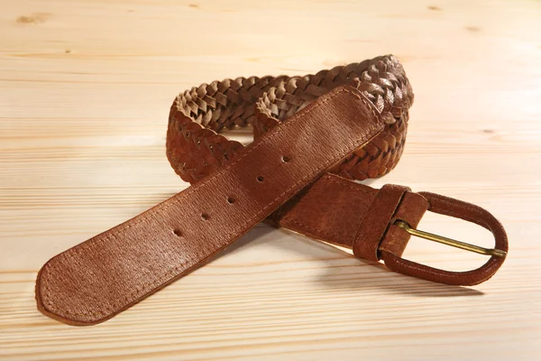 Leather braided men\'s belt on the table