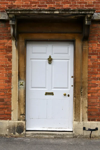 White Front Door of a Red Brick English Town House