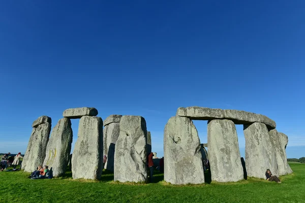Revellers gather at the ancient standing stone monument