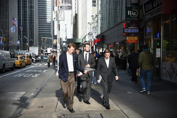 People walk on a busy Manhattan street