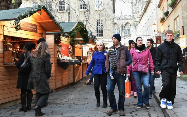 People visit the Christmas Market in the streets surrounding Bath Abbey