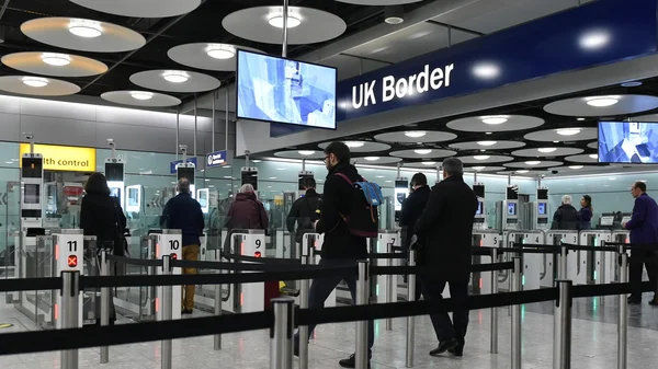 Air travellers pass through customs channels at Heathrow Airport.