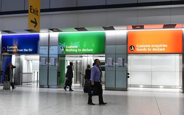 Air travellers pass through customs channels at Heathrow Airport.