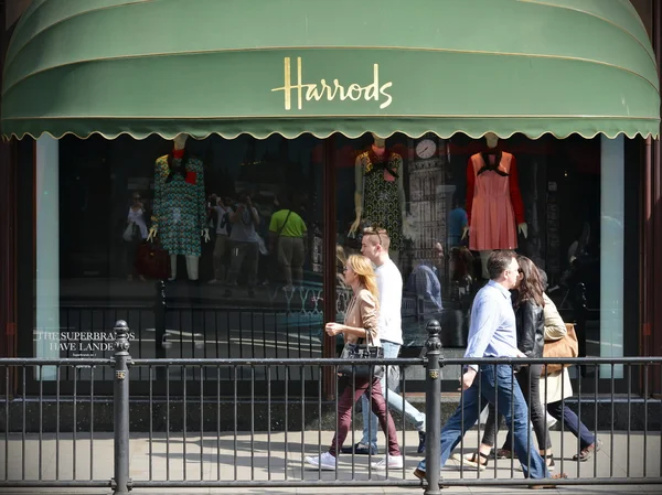 People walk past the famous Harrods store