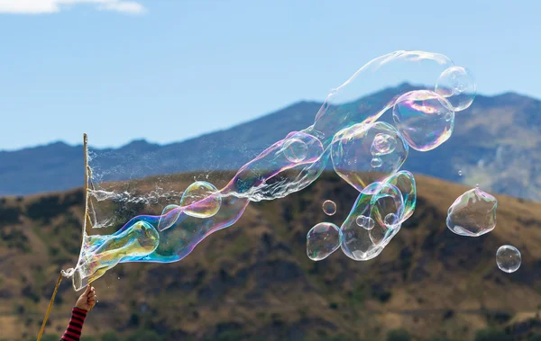 Soap bubble with mountain and blue sky background