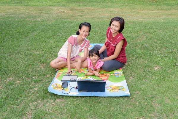 Smiling family using laptop outdoor