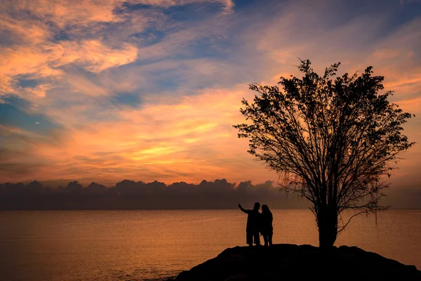 Silhouette couple holding hand