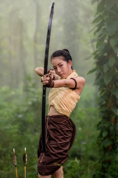 Beautiful archery woman aiming
