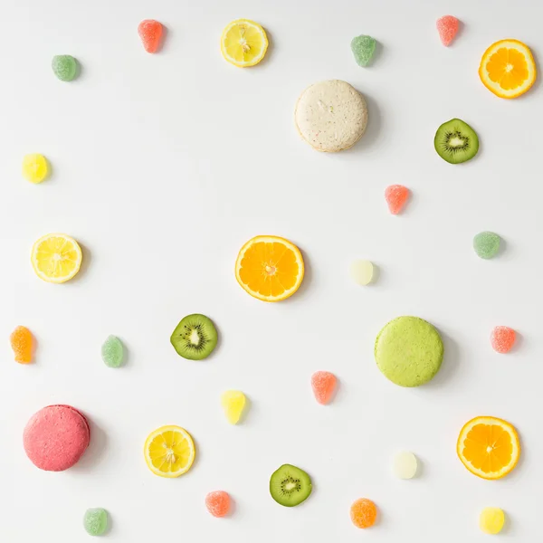 Colorful bright fruit pattern with sweets on white background.