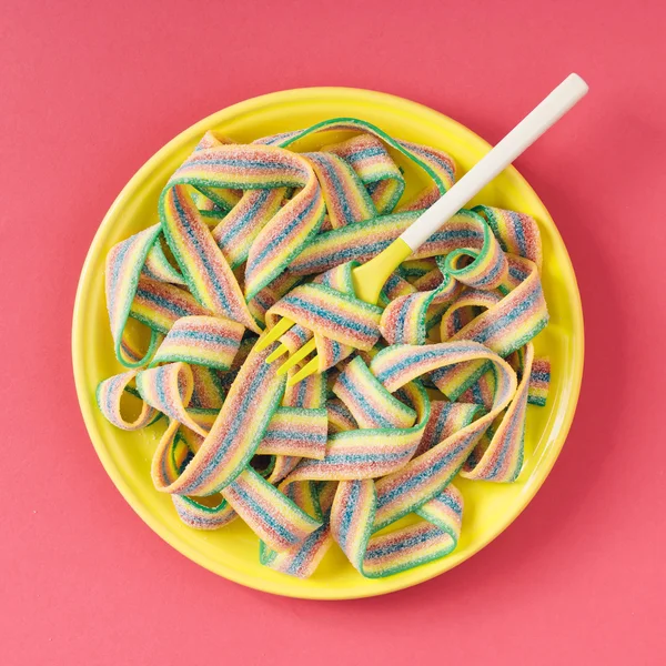 Bowl of candy stripes with fork.