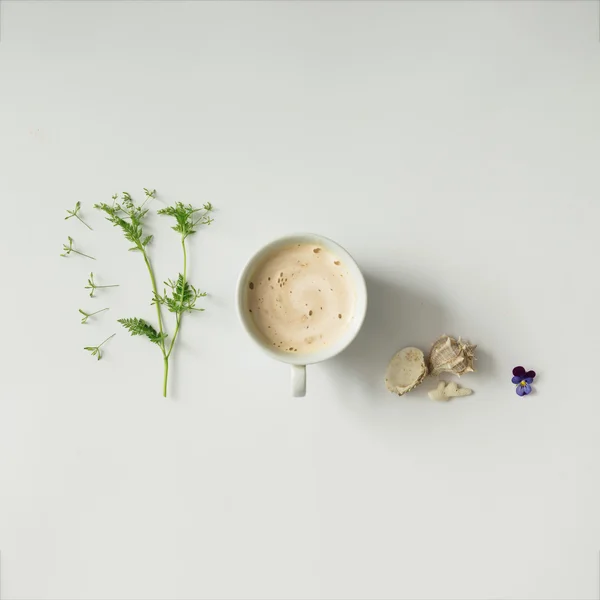 Coffee cup with flowers and sea shells