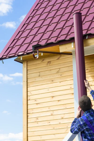 Work makes for a roof gutter