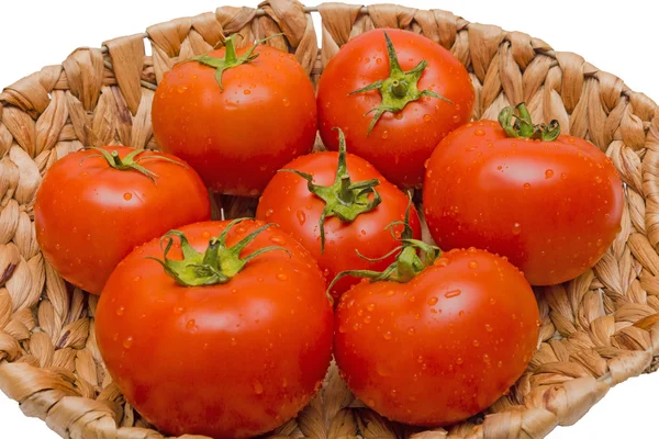 Fresh tomatoes in a basket on a white background