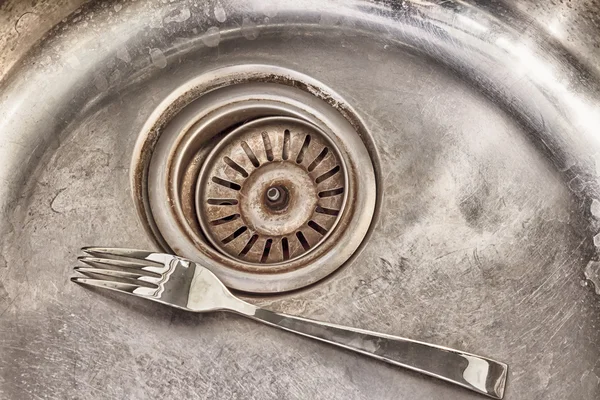 Detail shot of a old dirty sink with scrubber inside