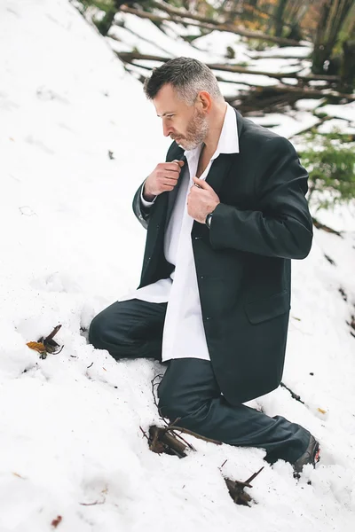 A bearded man in the costume winter snow woods