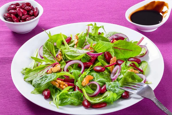 Red beans salad with mix of lettuce leaves and walnuts