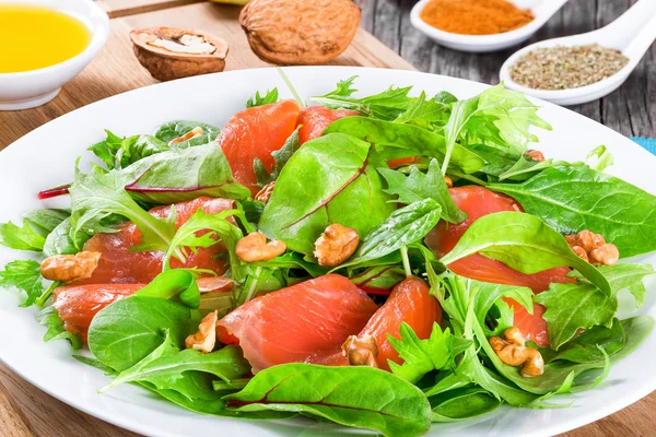 Red fish salad with mixed lettuce leaves