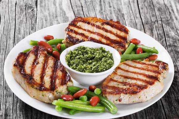 Grilled pork chops on a white dish