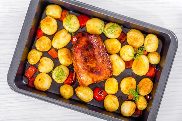 New potatoes Baked with  pork tenderloin  in a baking dish