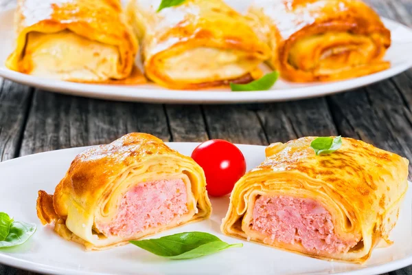 Portion of rolled pancakes or crepes stuffed with minced meat