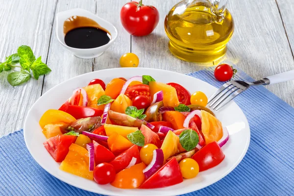 Tomato salad with mint leaves and olive oil