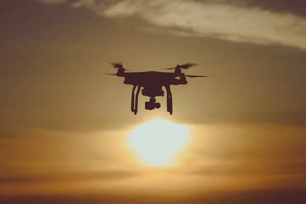 Flying drone at sunset